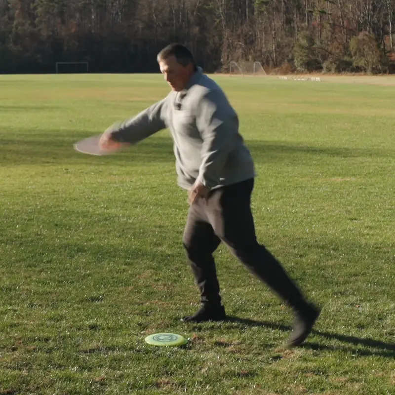 A disc golf throw at the release, with a line drawn from the head to the plant foot and a 92 degree angle marked at the shoulder.